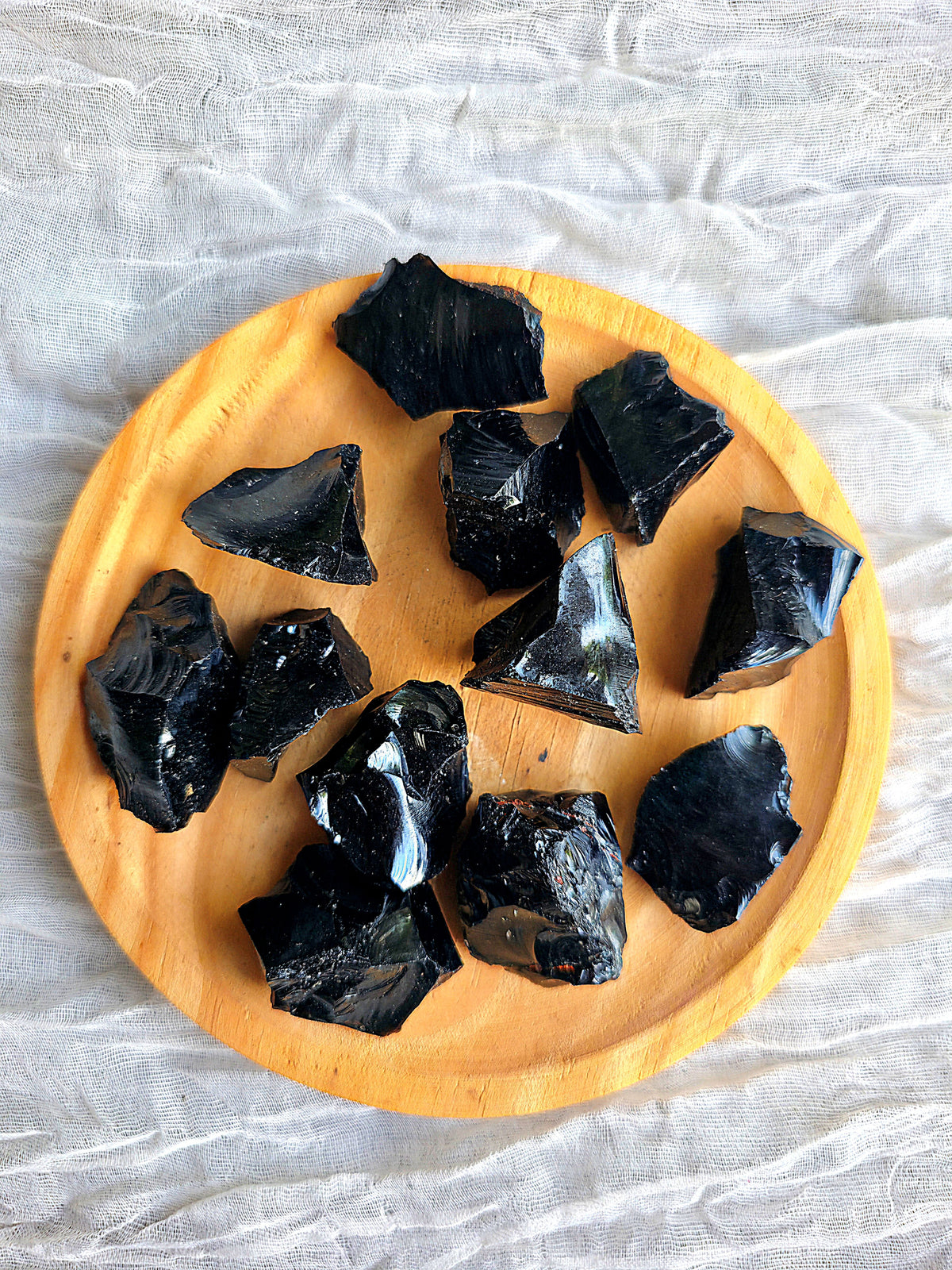 Pieza de obsidiana negra en bruto masivo mostrando su brillo natural y textura irregular.