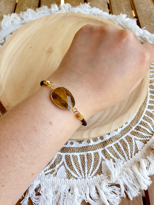 Pulsera de ojo de tigre facetada en cordón negro ajustable, joya de protección y confianza personal.
